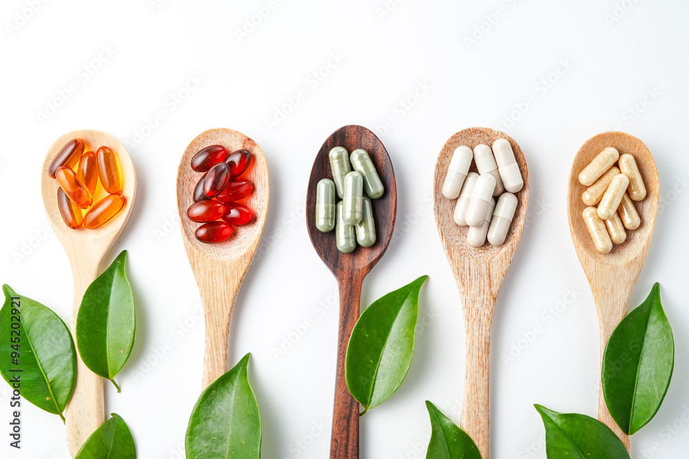Top view Variety of vitamin and mineral pills in wooden spoon, Dietary supplement healthcare Top view Variety of vitamin and mineral pills in wooden spoon, Dietary supplement healthcare