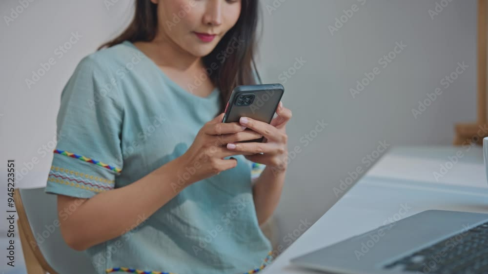 Close up of Asian beautiful woman using mobile phone device in house. Close up of Asian beautiful woman using mobile phone device in house.