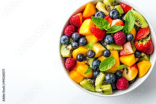 Colorful fruit salad in a bowl with mint leaves.