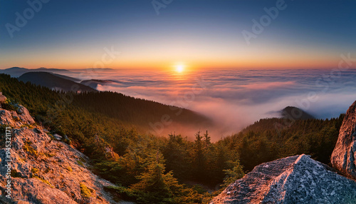 Amanecer desde la montaña sobre un bosque mediterráneo en el que se posa la niebla photo