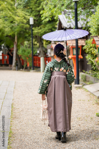 Unidentified woman wearing Hakama with a japanese style umbrella.