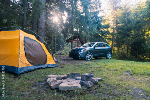 Картината върху платно Camping Scene with SUV and Yellow Tent