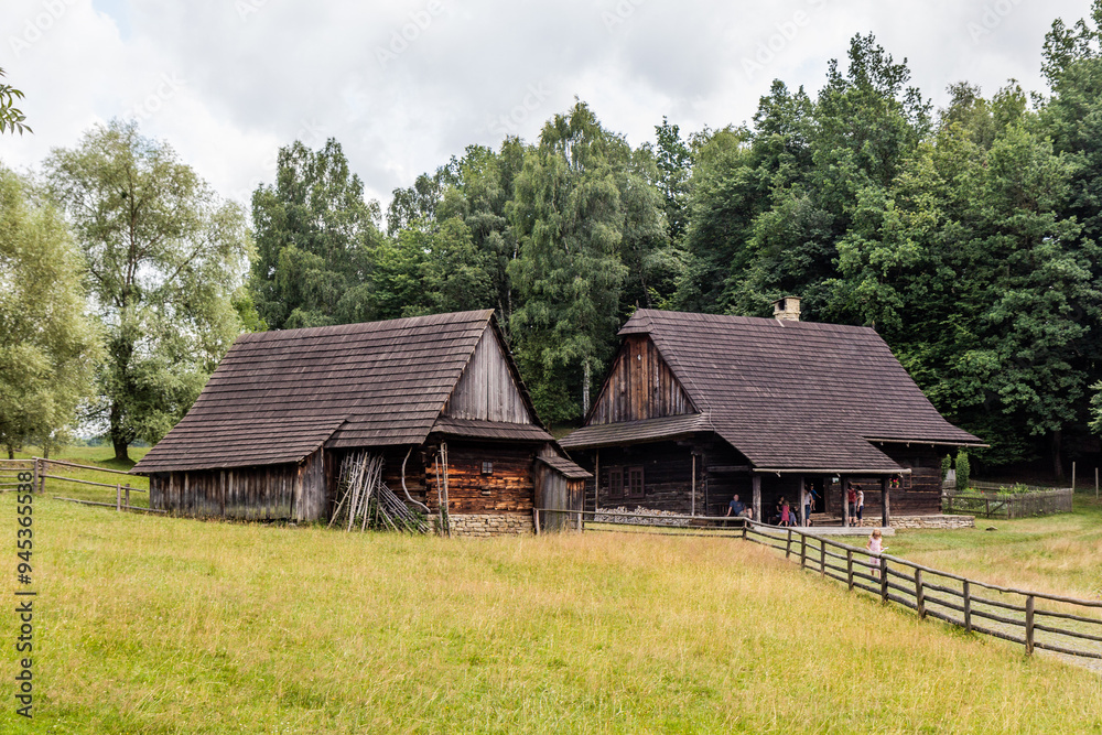 ROZNOV POD RADHOSTEM, CZECH REPUBLIC - JULY 15, 2021: Wooden houses in the open air museum (Valasske muzeum v prirode) in Roznov pod Radhostem, Czechia ROZNOV POD RADHOSTEM, CZECH REPUBLIC - JULY 15, 2021: Wooden houses in the open air museum (Valasske muzeum v prirode) in Roznov pod Radhostem, Czechia