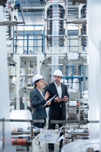 The teamwork of male and female engineers has significantly improved industrial machinery through the application of advanced technology for high-quality product performance.