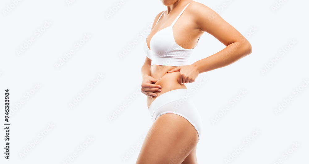 © Dimid - Girl pulls the skin on the abdomen, showing the body fat. Treatment and disposal of excess weight, the deposition of subcutaneous fat. © Dimid - Girl pulls the skin on the abdomen, showing the body fat. Treatment and disposal of excess weight, the deposition of subcutaneous fat.