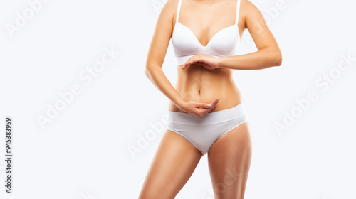 Girl pulls the skin on the abdomen, showing the body fat. Treatment and disposal of excess weight, the deposition of subcutaneous fat.