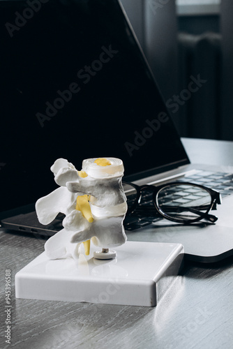 Modern spine model on a physiotherapist’s desk, reflecting advanced treatment methods and personalized care plans. Ideal for showcasing contemporary approaches to spinal health and rehabilitation. photo