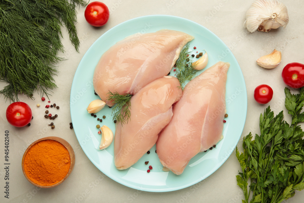 Raw chicken fillet on a cutting board on light background. Top view Raw chicken fillet on a cutting board on light background. Top view
