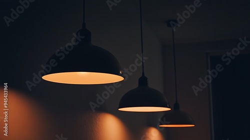 Wallpaper Mural Three round pendant lights hang from the ceiling and cast soft orange light on a dark wall. Torontodigital.ca
