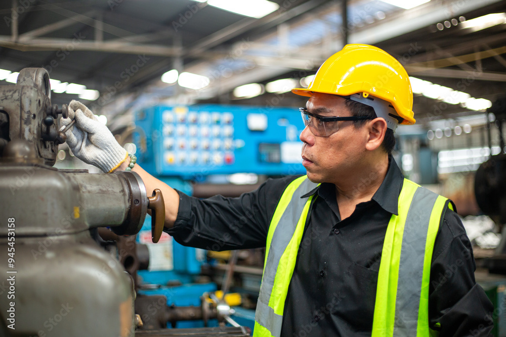 Operational level employees worker man wearing uniform safety and hardhat working machine lathe metal in factory industrial, engineer workers manufacturing industry. repair service man at workshop.