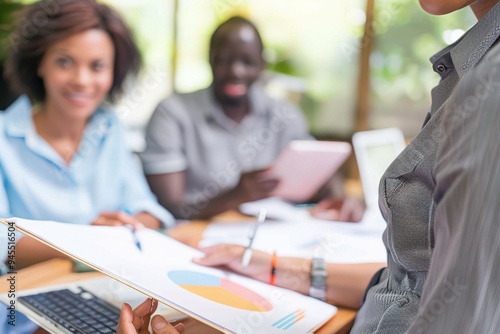 Business people in meeting looking at pie chart 