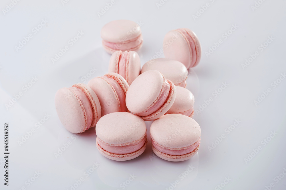 Fototapeta premium Pink colored. Bunch of macarons on the white surface
