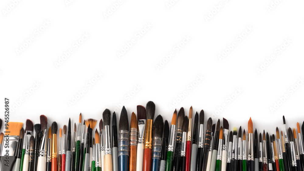 Mix of paint brushes in a row isolated on a white background. Mix of paint brushes in a row isolated on a white background.