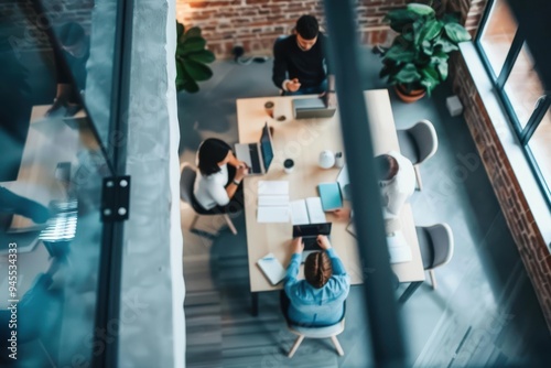 Business people in meeting. Top view shot of defocused business colleagues discussing over a new project in office. Above view of multi-ethnic group of confident business persons sitting on a conferen photo