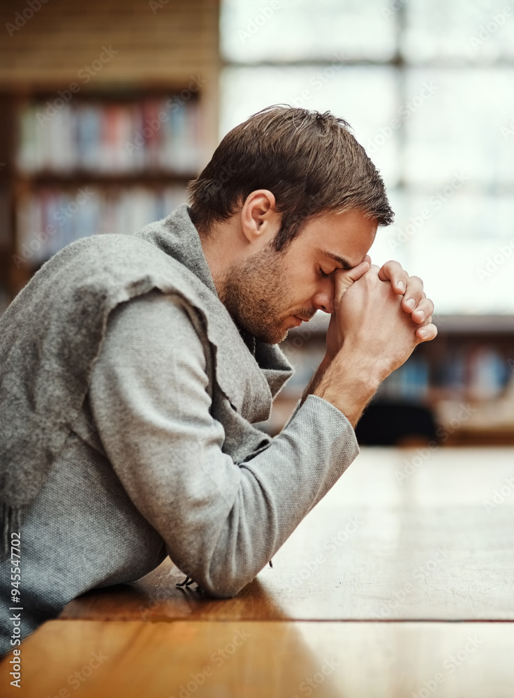 Man, praying and spiritual in university for study, worship and college scholarship in library. Student, faith and meditation to God on campus for school project, education and final exam or test Man, praying and spiritual in university for study, worship and college scholarship in library. Student, faith and meditation to God on campus for school project, education and final exam or test