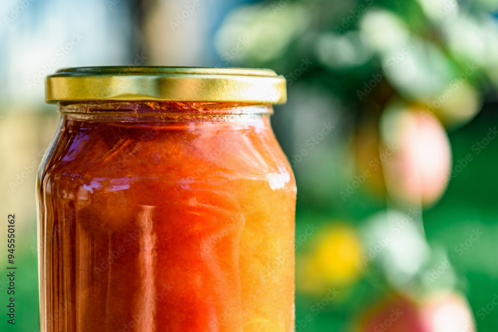 Glass jar of apple jam and fresh fruits on garden background. Glass jar of apple jam and fresh fruits on garden background.