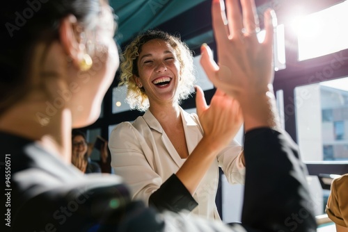 blond businesswoman high fiving a colleague photo