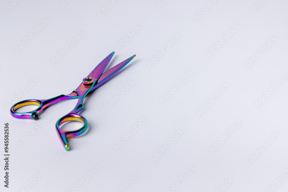 Detailed image of open scissors on the left side against a white background Detailed image of open scissors on the left side against a white background