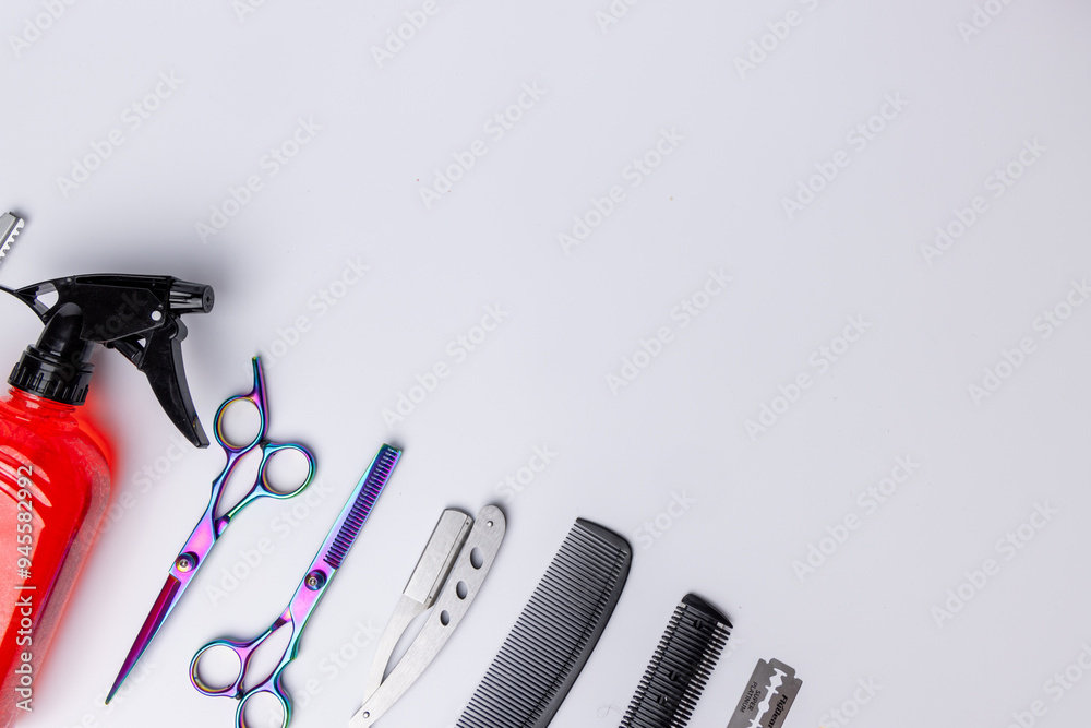 Aerial view of barber tools, including a red flux, placed neatly on a white surface Aerial view of barber tools, including a red flux, placed neatly on a white surface