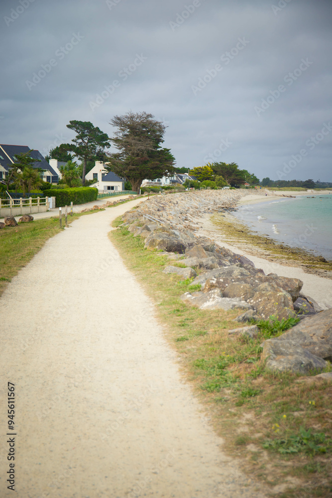 Path along Grand Plage beach in the charming village of Ile-Tudy, Finistere, Brittany, France. Vertical shot. Path along Grand Plage beach in the charming village of Ile-Tudy, Finistere, Brittany, France. Vertical shot.