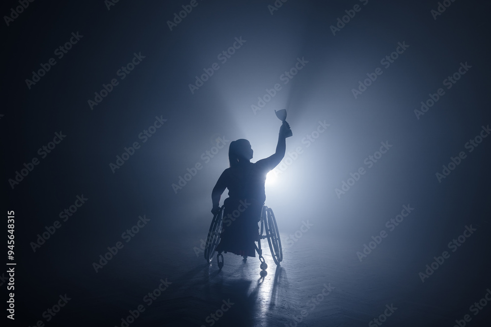 Woman with disability hoisting a trophy in the air to celebrate a sports victory and accomplishment. Success concepts. Woman with disability hoisting a trophy in the air to celebrate a sports victory and accomplishment. Success concepts.