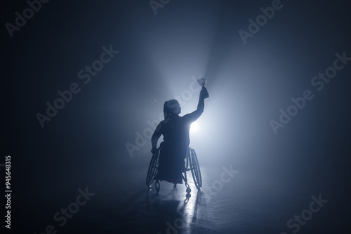 Schilderij op canvas Woman with disability hoisting a trophy in the air to celebrate a sports victory and accomplishment
