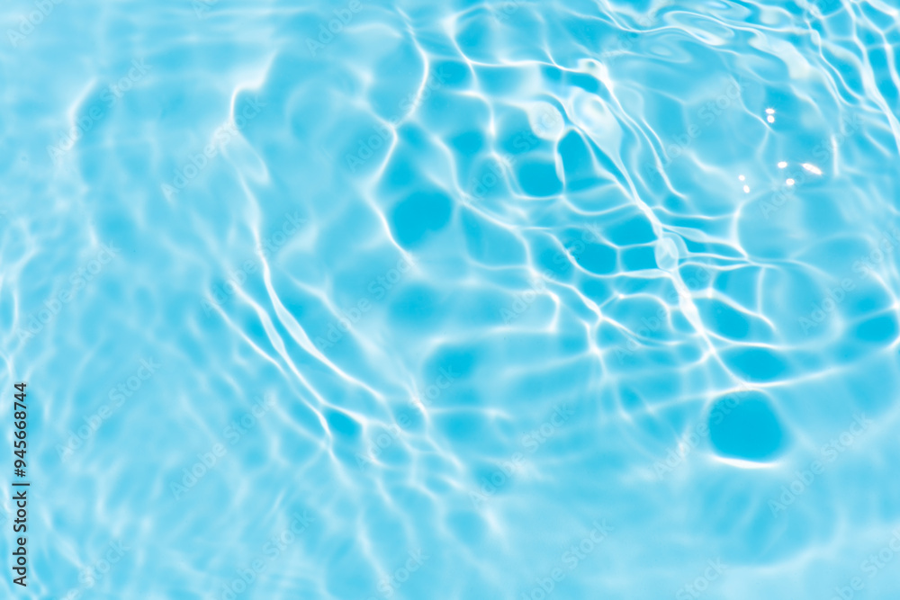 Blue water with ripples on the surface. Defocus blurred transparent blue colored clear calm water surface texture with splashes and bubbles. Water waves with shining pattern texture background. Blue water with ripples on the surface. Defocus blurred transparent blue colored clear calm water surface texture with splashes and bubbles. Water waves with shining pattern texture background.