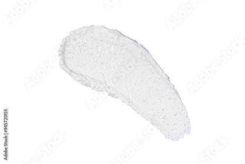 A white smear of face scrub on a light blue background, isolated smudge