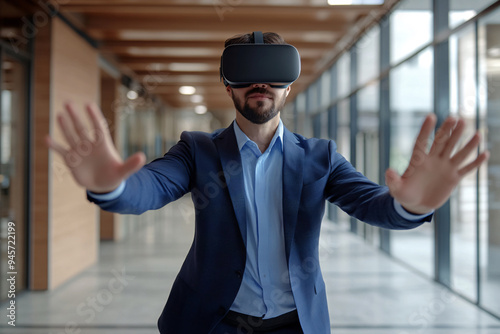 Businessman in VR Headset: A businessman in a suit explores the digital world, wearing a VR headset with open arms. The modern office setting provides a glimpse into the future of business, where virt photo