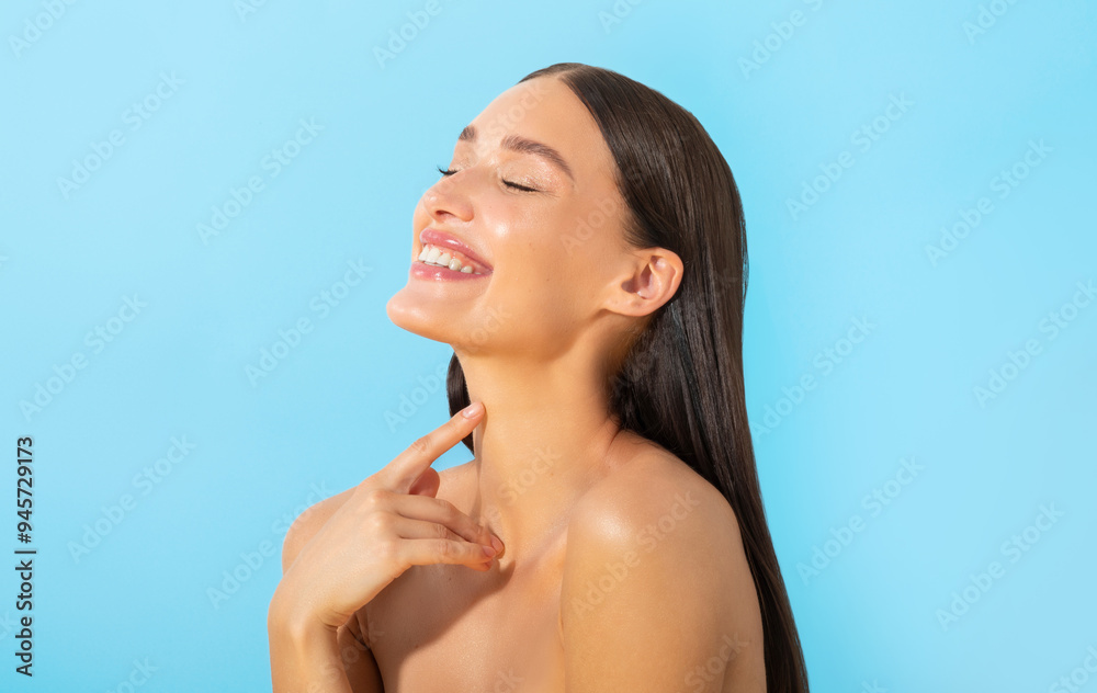Attractive lovely European lady enjoy her silky skin effect after lotion, posing isolated over blue background Attractive lovely European lady enjoy her silky skin effect after lotion, posing isolated over blue background