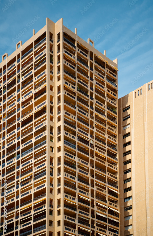 A high-rise building stands tall against a clear sky A high-rise building stands tall against a clear sky