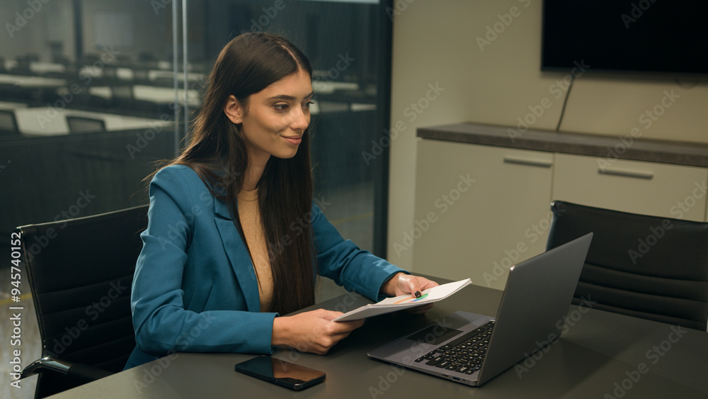 Indian smiling business woman talking to laptop computer web camera video call conference speaking at webcam online chat negotiation meeting businesswoman with document papers discuss project studying Indian smiling business woman talking to laptop computer web camera video call conference speaking at webcam online chat negotiation meeting businesswoman with document papers discuss project studying