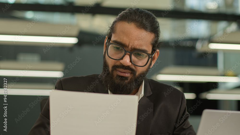 Arabian Muslim business man Indian businessman employer entrepreneur manager confused with papers and laptop in office problem paperwork bad result talking video call working with documents failure Arabian Muslim business man Indian businessman employer entrepreneur manager confused with papers and laptop in office problem paperwork bad result talking video call working with documents failure