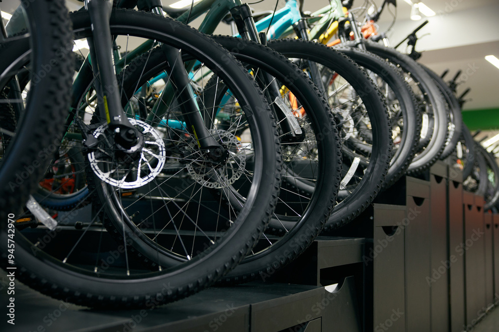 Mountain bike on rack showcase in shop closeup on bicycle wheels