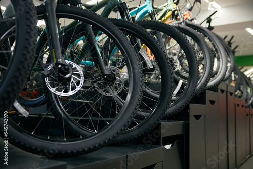 Obraz na płótnie Mountain bike on rack showcase in shop closeup on bicycle wheels w salonie