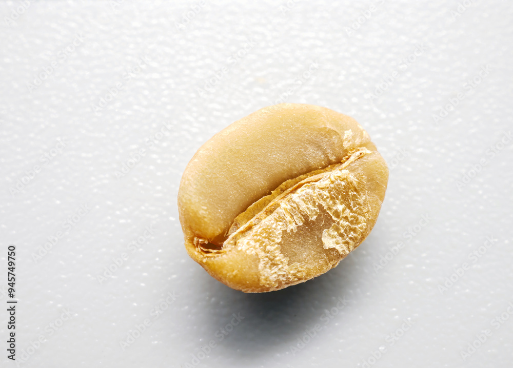 Green coffee bean seed on white background, Close-up unroasted coffee bean, macro photo of raw coffee bean Green coffee bean seed on white background, Close-up unroasted coffee bean, macro photo of raw coffee bean