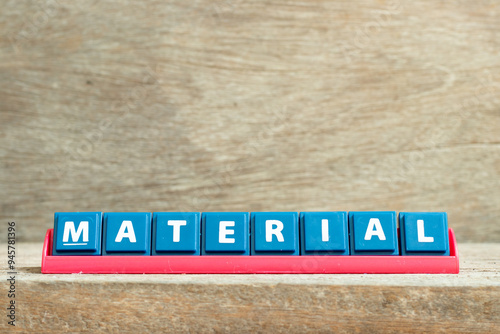 Tile letter on red rack in word material on wood background
