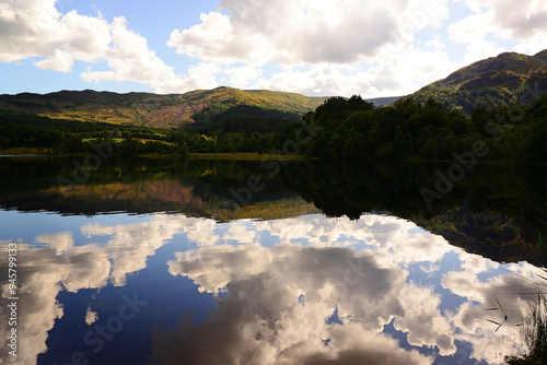 Sky reflections in Loch Achray, in the Trossachs area of Scotland photo