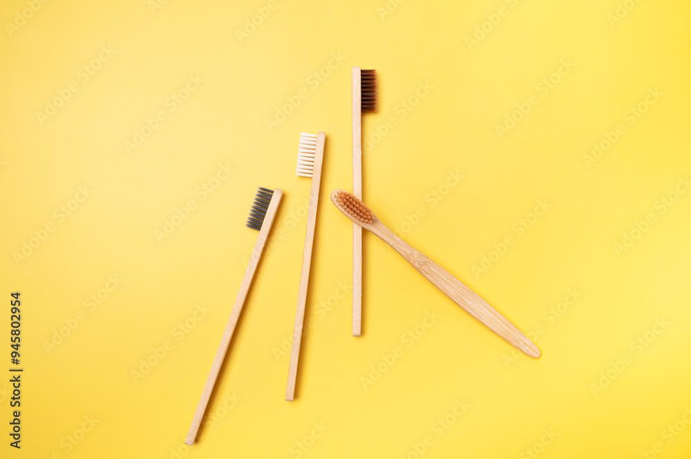 Eco-friendly dental wooden bamboo toothbrushes on yellow background. Dental care and health, plastic-free life, zero waste, save the planet. Flat lay top view copy space Eco-friendly dental wooden bamboo toothbrushes on yellow background. Dental care and health, plastic-free life, zero waste, save the planet. Flat lay top view copy space