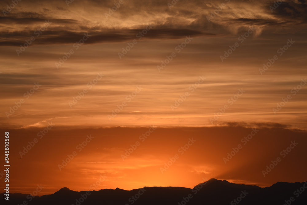 Panorama of mountains and cloudy sky at dusk