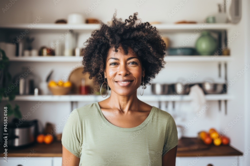 Portrait of a middle aged African American fit woman in healthy kitchen Portrait of a middle aged African American fit woman in healthy kitchen