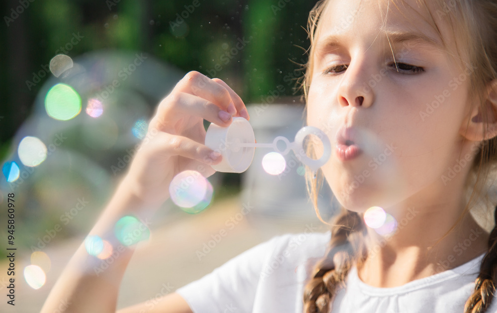 Cute beautiful girl blowing soap bubbles in the park, playing and having fun on a warm sunny weekend. Cute beautiful girl blowing soap bubbles in the park, playing and having fun on a warm sunny weekend.