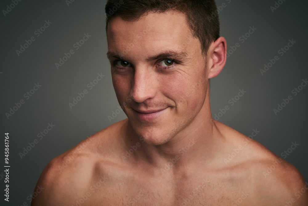 Skincare, health and portrait of man in studio for wellness, facial treatment and grooming. Dermatology, salon and face of person with smile, confidence and pride for natural skin on gray background Skincare, health and portrait of man in studio for wellness, facial treatment and grooming. Dermatology, salon and face of person with smile, confidence and pride for natural skin on gray background