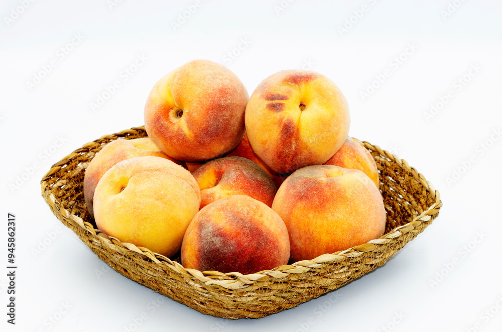 Peach, one of the most beautiful fruits of the summer season with its taste and smell, in a basket Peach, one of the most beautiful fruits of the summer season with its taste and smell, in a basket