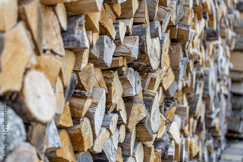 Background of stacked chopped wood logs. Pile of wood logs ready for winter. Wooden stumps, firewood stacked in heap