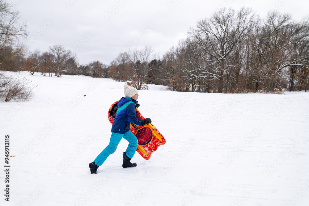 young girl running with sled on hill in winter snow outdoors young girl running with sled on hill in winter snow outdoors