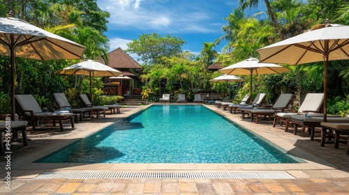 Wallpaper Mural Elegant umbrellas and chairs surrounding a luxurious swimming pool at a hotel resort, perfect for a holiday vacation. Torontodigital.ca