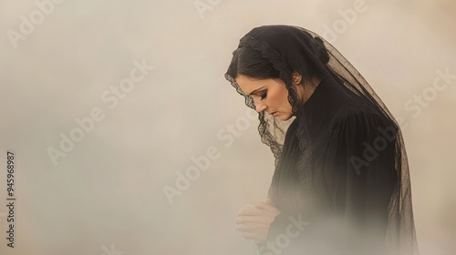 Serene Woman in Black Mantilla Praying in Soft Light