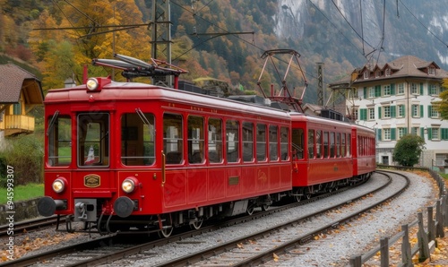 Famous electric red tourist panoramic train in swiss village Lungern, canton of Obwalden, Switzerland