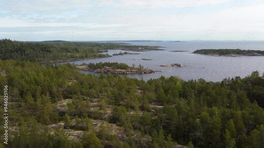 Russia, Lake Ladoga, Koyonsaari. View of the coast of the island in a cold lake. Beautiful nature of the Republic of Karelia. Panoramic view from the height of the Ladoga skerry islands. 4K Russia, Lake Ladoga, Koyonsaari. View of the coast of the island in a cold lake. Beautiful nature of the Republic of Karelia. Panoramic view from the height of the Ladoga skerry islands. 4K